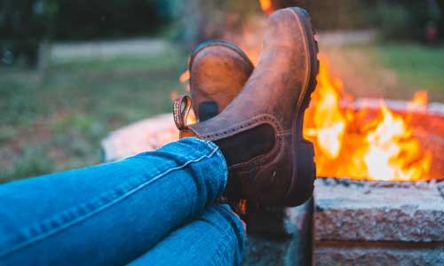 booted feet near fire pit