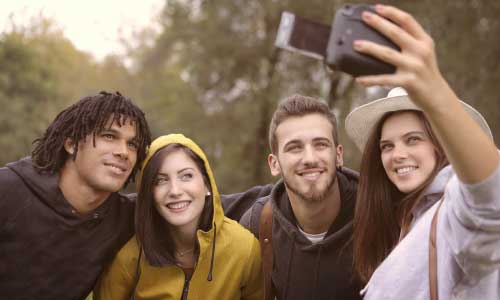 young people taking a selfie and smiling