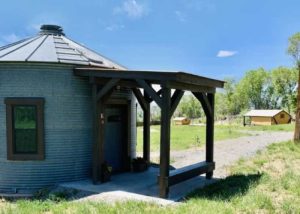 Fort Austin Grain Bin turned bath house that includes two each of toilets, sinks, and showers